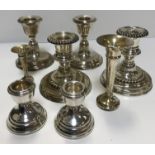 Three pairs of silver squat candlesticks, all on circular bases (various makers),