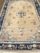 A Chinese Superwash rug, the central panel set with dragon motif on a gold ground,