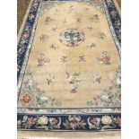 A Chinese Superwash rug, the central panel set with dragon motif on a gold ground,