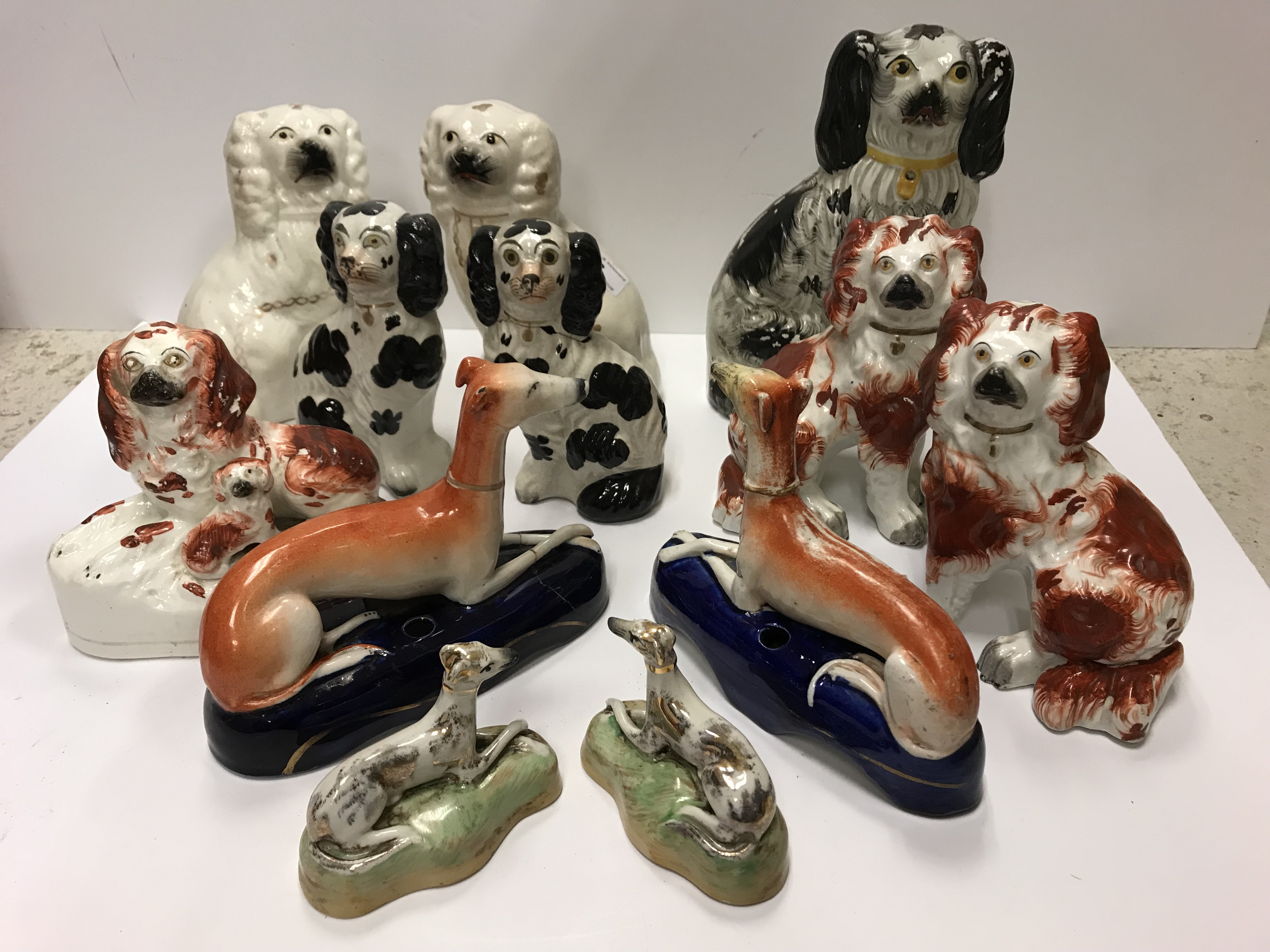 A collection of 19th Century Staffordshire Spaniel figures including a pair...