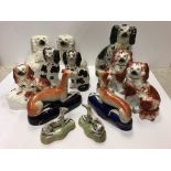 A collection of 19th Century Staffordshire Spaniel figures including a pair of "White Spaniels with