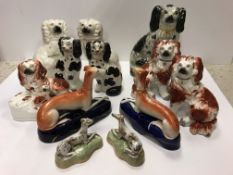 A collection of 19th Century Staffordshire Spaniel figures including a pair of "White Spaniels with