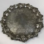 WITHDRAWN A late George III silver salver with engraved decoration and pie crust rim raised on