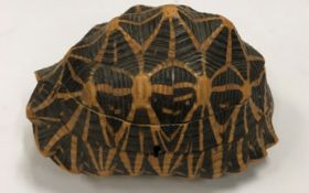 An early 20th Century mounted tortoiseshell box with parquetry inlaid decoration to the interior 18.