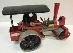 A Wilesco "Old Smoky" live steam engine with chain driven steering, red painted,