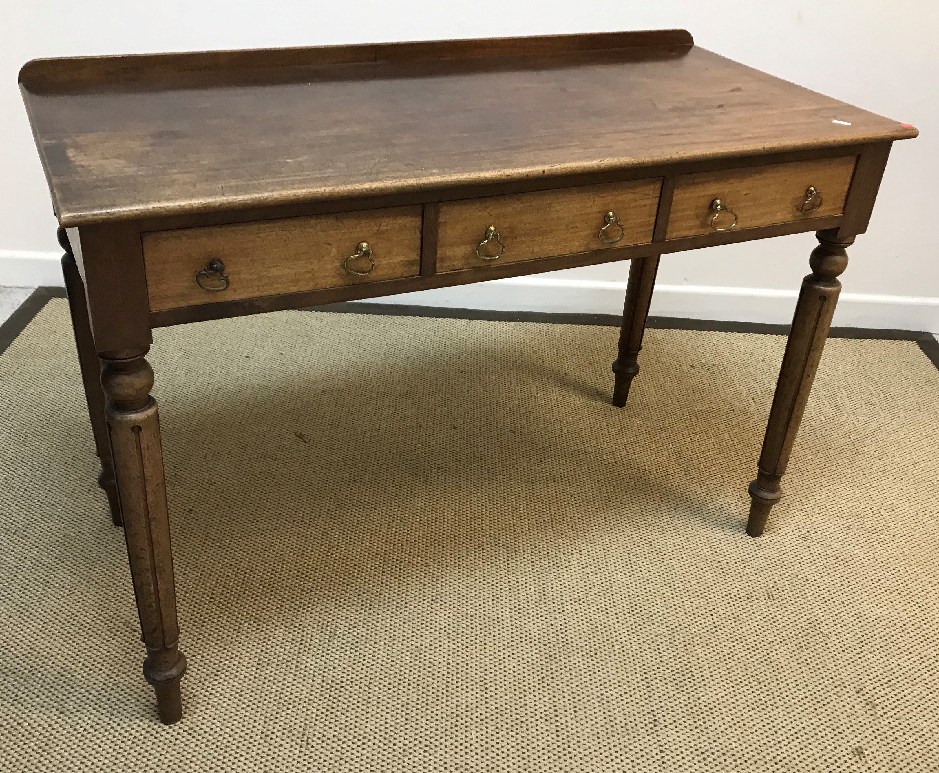 A circa 1800 oak tea table, the oval top on a birdcage to turned tapering pedestal and tripod base,