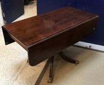 An early 19th Century mahogany twin pillar dining table as two drop-leaf Pembroke tables on turned