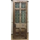 A late Victorian pine framed exterior door with four foliate and floral decorated leaded glazed