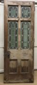 A late Victorian pine framed exterior door with four foliate and floral decorated leaded glazed