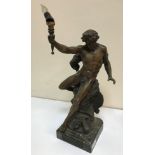 A 19th Century spelter table lamp in the form of a male nude on rocky outcrop holding aloft a torch,