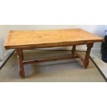 A modern pine farmhouse style draw leaf kitchen table on turned and ringed supports united by a