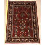 A Kashan prayer rug, the central panel set with Mirhab design with vase of flowers to base,