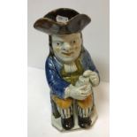 A 19th Century Staffordshire glazed pottery Toby jug as "Toby Philpott seated with jug of ale on