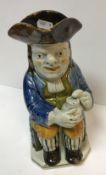 A 19th Century Staffordshire glazed pottery Toby jug as "Toby Philpott seated with jug of ale on