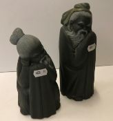 Two Lladro figures of "Chinese gentlemen", in dark glaze, 20 cm and 16.