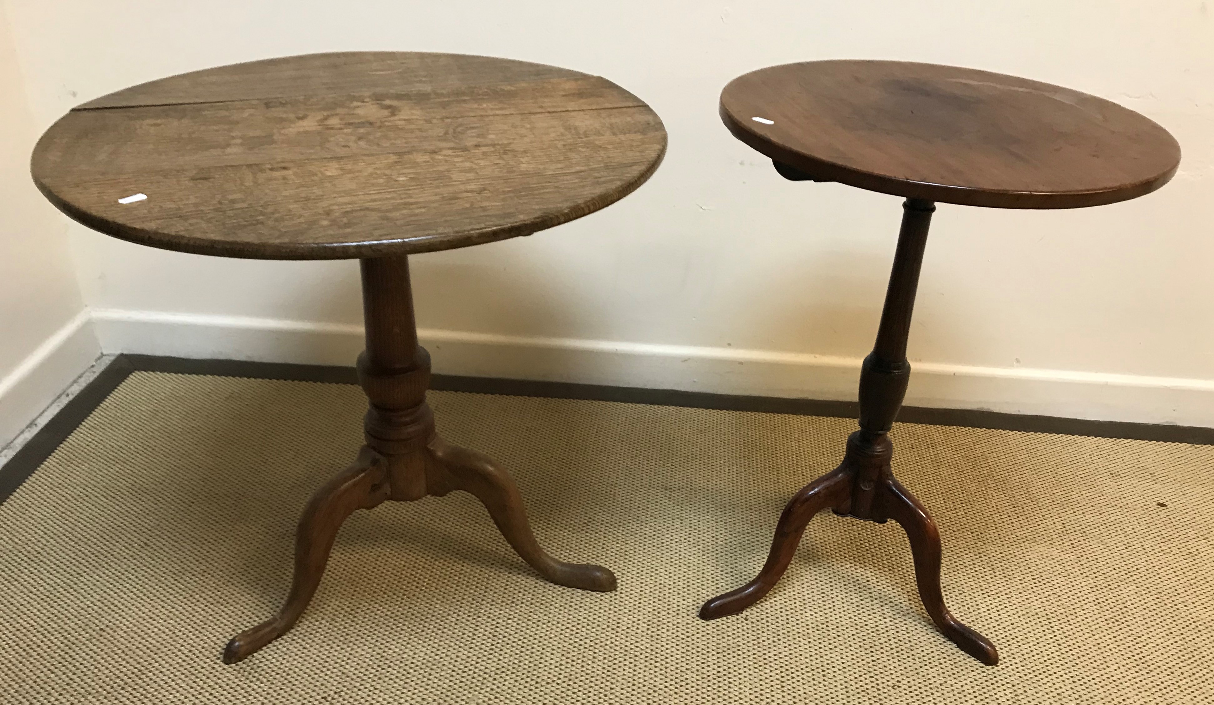 A 19th Century oak tea table, the circular snap top on a turned pedestal to cabriole tripod base,