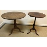 A 19th Century oak tea table, the circular snap top on a turned pedestal to cabriole tripod base,