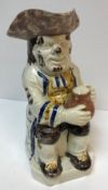 A 19th Century Staffordshire pottery Toby jug as "Toby Philpott seated with a jug of ale on his