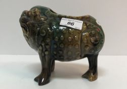 A Burmantofts "Grotesque" green/brown glazed relief work decorated figure of a kylin as a vase 17.