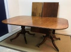 An early 19th Century mahogany dining table,
