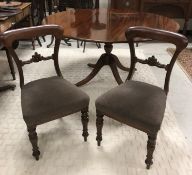 A set of six Victorian mahogany bar back dining chairs with upholstered seats on flower head carved