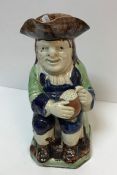 A 19th Century pearl ware glazed pottery Toby jug as "Toby Philpott seated with jug of ale on his