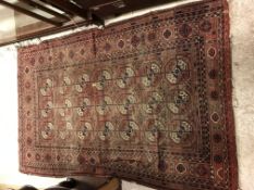 A Bokhara rug, the central panel set with a stepped black geometric pattern border,