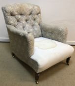 A circa 1900 upholstered armchair by Howard & Sons of London with original "H & S" ticking to the