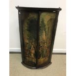 An 18th Century lacquered and painted bow fronted hanging corner cupboard,