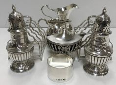 A collection of small silver wares to include a pair of peppers,