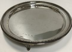A George VI silver circular card tray of plain form with egg and dart rim,