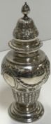 A Victorian silver sugar caster with embossed ribbon and swag decoration raised on a circular