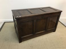 An 18th Century oak coffer, the three panel top over a three panel front on stile supports, 117.