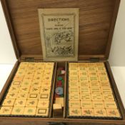 A carved teak cased Mahjong set together with Man Fung Cheung directions of playing Chinese game of