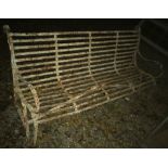 An early 20th Century painted wrought iron garden bench of slatted form with scroll arms,