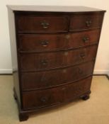 An Edwardian mahogany and satinwood strung bow fronted chest of two short over four long graduated