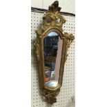 A pair of 18th Century carved giltwood girandole mirrors of tapered form with shell and foliate