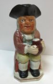 A 19th Century Staffordshire pottery Toby jug as "Toby Philipott seated with jug of ale on his left