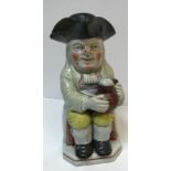 A 19th Century Staffordshire pottery Toby jug as "Toby Philpott with jug of ale on his left knee,