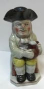 A 19th Century Staffordshire pottery Toby jug as "Toby Philpott with jug of ale on his left knee,