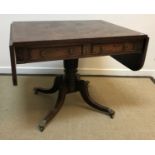 A late Regency mahogany drop-leaf sofa table with two frieze drawers opposite two dummy drawers,