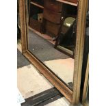 A large gilt gesso framed rectangular wall mirror in the 19th Century manner with ribbon tied