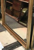 A large gilt gesso framed rectangular wall mirror in the 19th Century manner with ribbon tied