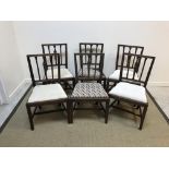 A set of six 19th Century mahogany dining chairs with carved back rails over a drop-in seat,