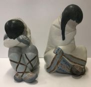 Two Lladro figures of "Seated children", one with crossed legs and head resting upon arms,