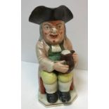 A 19th Century Staffordshire pottery Toby jug as "Toby Philpott seated with a jug of ale on his