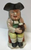 A 19th Century Staffordshire pottery Toby jug as "Toby Philpott seated with a jug of ale on his