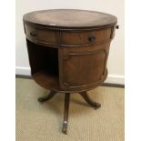 A reproduction mahogany drum book table of circular form,