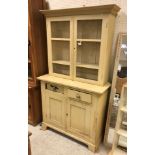 A painted pine dresser, the two chicken wire doors enclosing two shelves,