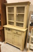 A painted pine dresser, the two chicken wire doors enclosing two shelves,